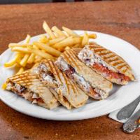 Greek Panini · Grilled chicken, feta, onion, tomato, olives and a touch of Tzatziki sauce. Served with choi...