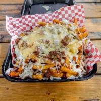 Rancho Fries · Natural and seasoned french fries loaded with nacho cheese on top with your choice of meat. ...