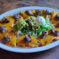 Fajita Nachos · Individual tortilla chips topped with refried beans, cheese, your choice of Beef or Chicken ...