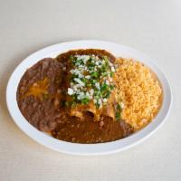Beef Enchiladas Plate · Beef enchiladas topped with chili con carne sauce and cheese, served with rice and beans, ga...