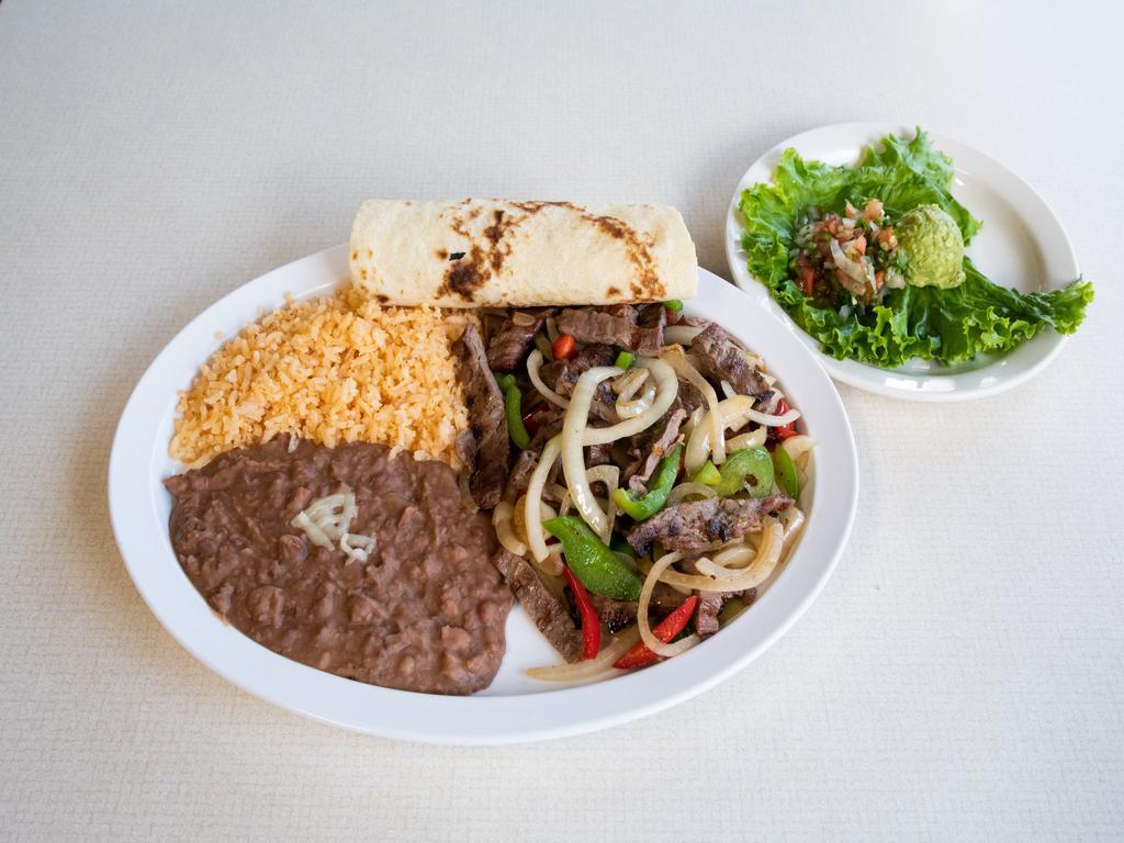 Bistek a la Mexicana · Thinly Sliced Grilled ribeye steak with grilled pepper and onions served with guacamole, pico de gallo, rice, beans and fresh tortillas.