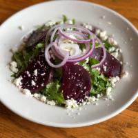 Roasted Beet and Arugula Salad · Roasted beets, arugula, and red onion tossed with lemon vinaigrette and topped with feta che...