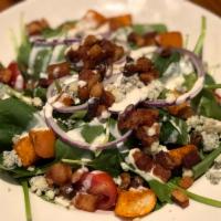 The Bacon Blue Cheese Spinach Salad · Fresh spinach topped with blue cheese dressing, crumbled blue cheese, warm bacon, tomato, re...