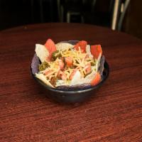 Taco Salad · Lettuce, cheddar cheese, corn tortilla chips, tomatoes, jalapenos, seasoned beef, and drizzl...
