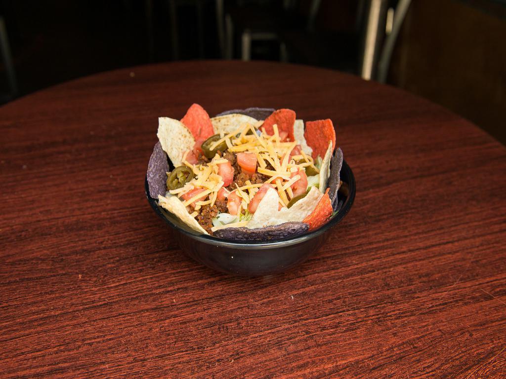 Taco Salad · Lettuce, cheddar cheese, corn tortilla chips, tomatoes, jalapenos, seasoned beef, and drizzled with chipotle dressing.