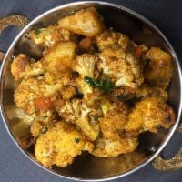 Aaloo Gobi ( choose spicy level ) · Cauliflower and potatoes cooked with herbs and spices.