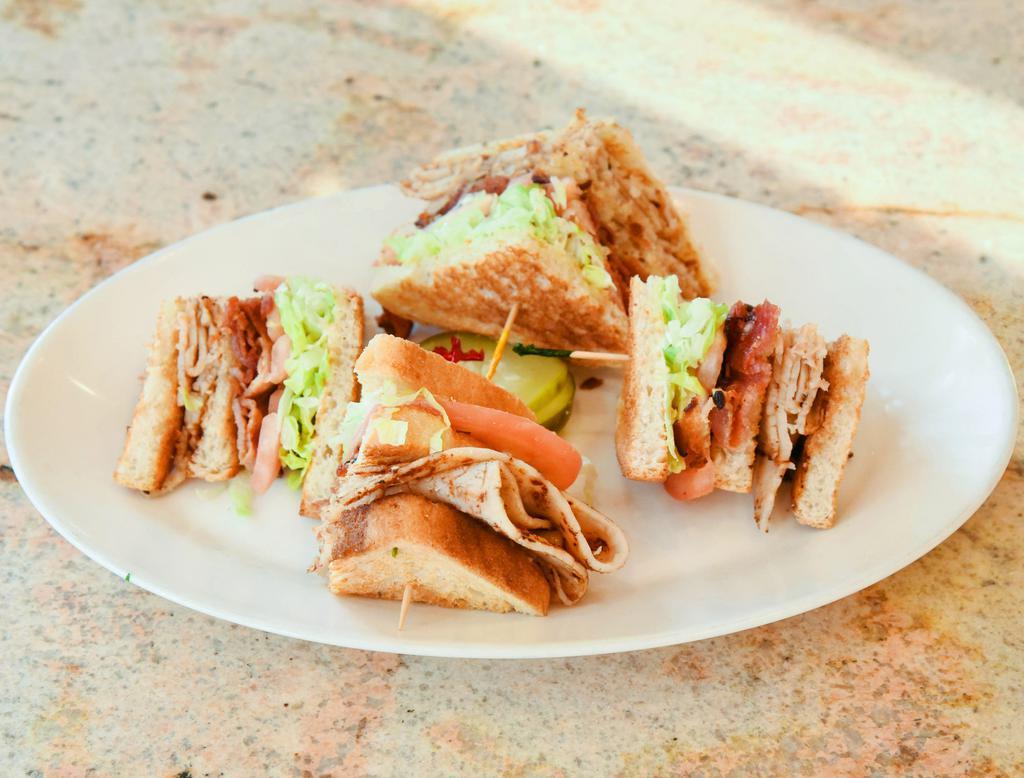 Turkey Club Sandwich · Bacon, sliced turkey, mayo, lettuce, tomato.