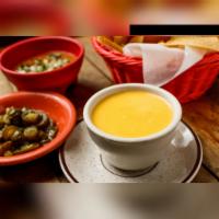 Chile con Queso · Melted cheese dip.
