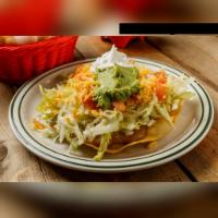 Tostada San Lorenzo · Large deep-fried flour tortilla topped with beans, beef or chicken fajita, lettuce, tomatoes...