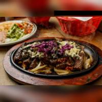 Fajitas Poblano Special · Beef or chicken fajitas grilled with poblano peppers, onions, and bacon. Topped with Montere...