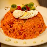 Arroz con Pollo · Shredded chicken breast mixed with yellow rice and vegetables. 