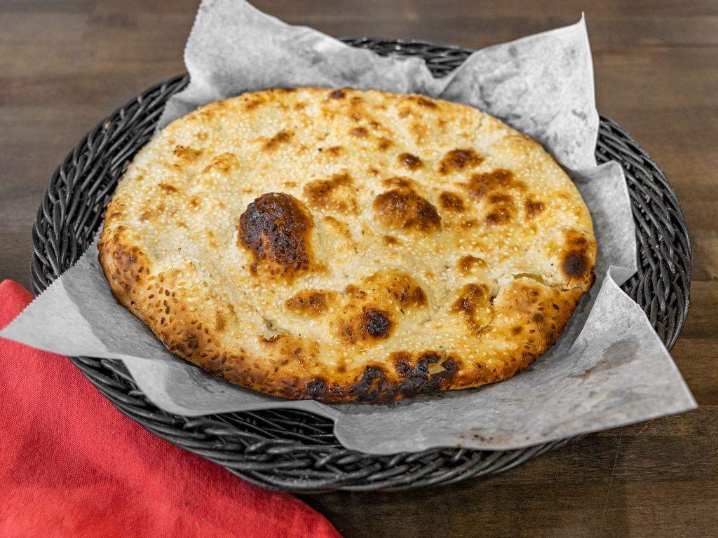 Kulcha  · Naan topped with sesame seeds.