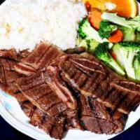 E4. Teriyaki Beef Ribs · 3 sliced beef ribs marinated and grilled in our own special sauce. Served with white rice an...