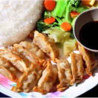 E5. Gyoza Plate · 9 pork and vegetable pot stickers deep-fried and served in our own dipping sauce. Served wit...