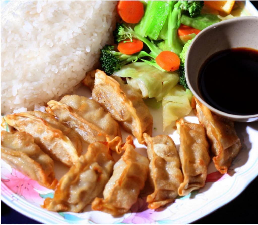 E5. Gyoza Plate · 9 pork and vegetable pot stickers deep-fried and served in our own dipping sauce. Served with white rice and stir-fried vegetables (cabbage, broccoli, and carrots).