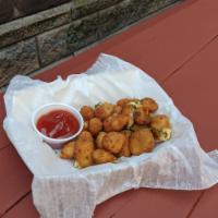 Cheese Curds · Hand breaded Wisconsin Jalapeno cheese curds. Served with ketchup. *Contains cheese*