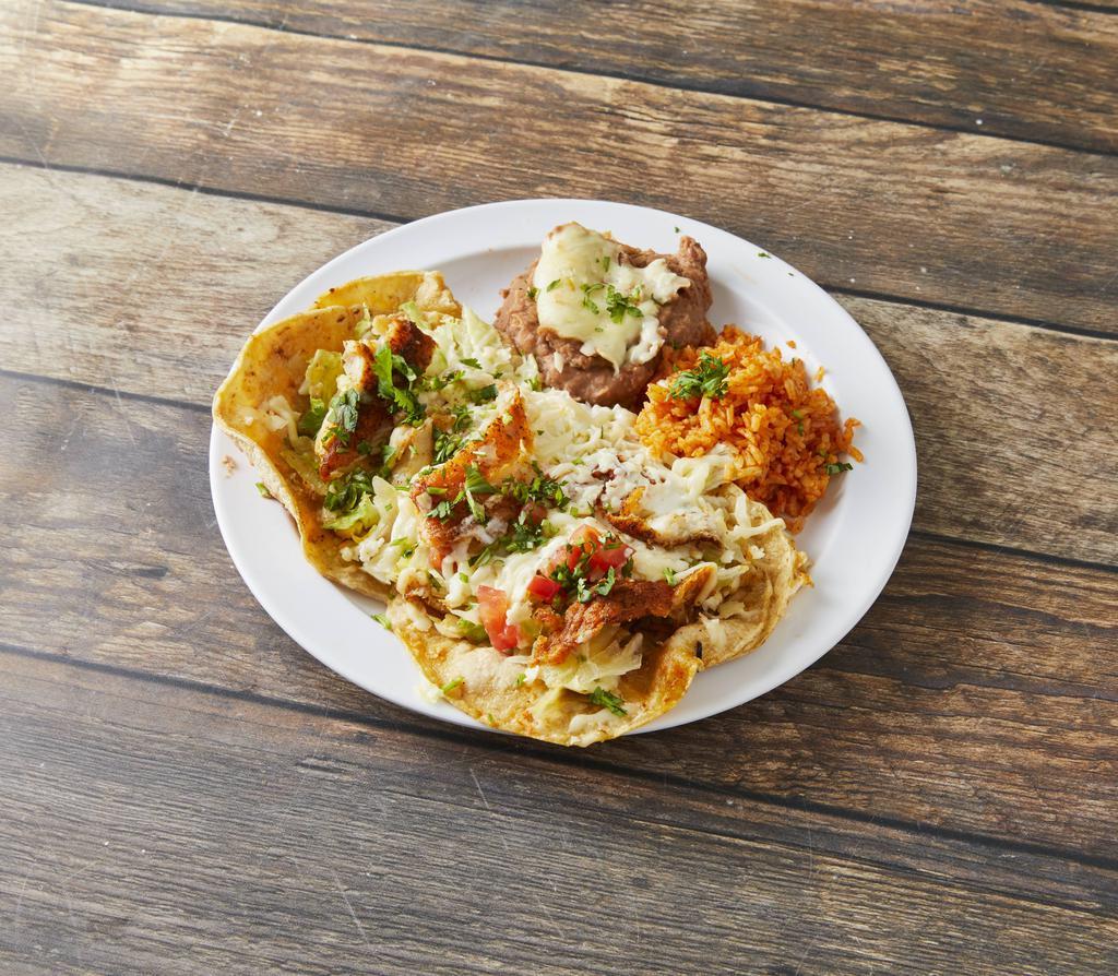 Taco Plate (2 Tacos) · Two tacos with your choice of meat, served with lettuce, tomato, sour cream, cheese, served alongside rice and beans.