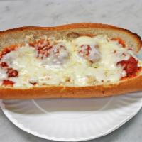 Meatballs Parmigiana Hero · Sandwich with seasoned meat that has been rolled into a ball topped with tomato sauce and ch...