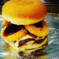 Bourbon Burger · A juicy burger with onion rings, Bourbon sauce and white American cheese on a toasted bun.