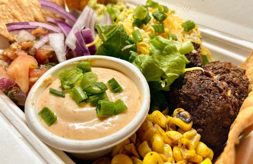 Southwest Bowl · Mixed grains, green leaf, shredded cheese, roasted corn, pico de Gallo, sour cream, pickled onion, Taza sauce. Add vegan falafel or roasted chicken.