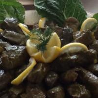 Dolmades Ampilofilo · Homemade stuffed grapevine leaves with rice and herbs.