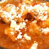 Garides Saganaki · Tender shrimp sauteed in fresh tomato, wine, butter and cheese.