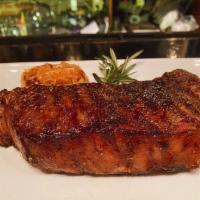 14 oz. Prime New York Strip Steak · *USDA PRIME* Black Angus strip steak, whole roasted head of garlic, and Maldon sea salt.