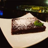 Chocolate Brownie · Warm house made chocolate brownie, dusted with powdered sugar.