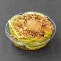 Apple Nachos · Thinly sliced green apples with a scoop of peanut butter in the center, caramel drizzle & wa...