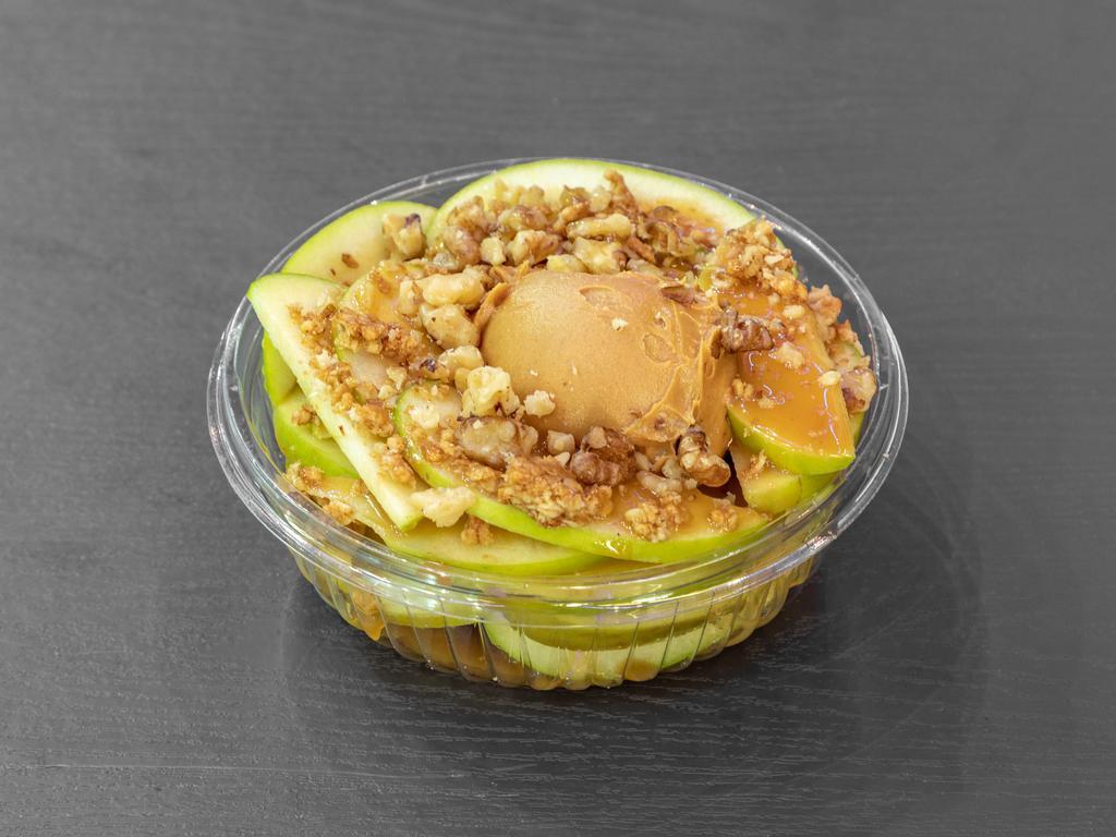 Apple Nachos · Thinly sliced green apples with a scoop of peanut butter in the center, caramel drizzle & walnuts and granola on top.
