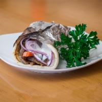 Gyro Sandwich · Juicy sliced beef marinated with Greek seasoning. Served on pita bread with cucumber sauce, ...