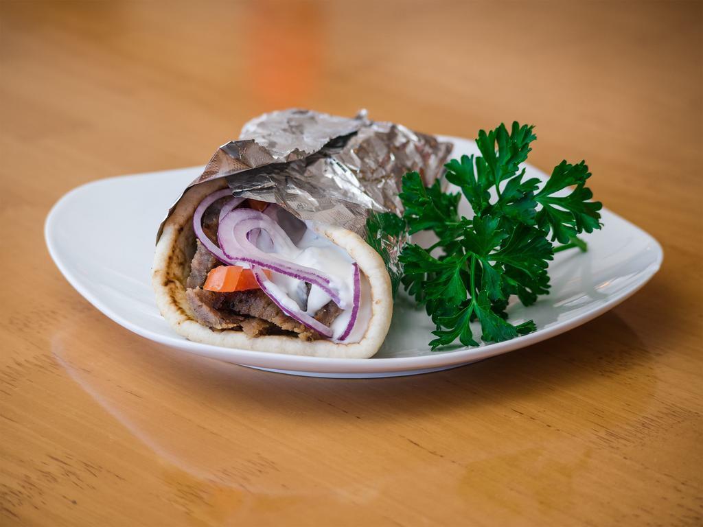 Gyro Sandwich · Juicy sliced beef marinated with Greek seasoning. Served on pita bread with cucumber sauce, onion and tomato.
