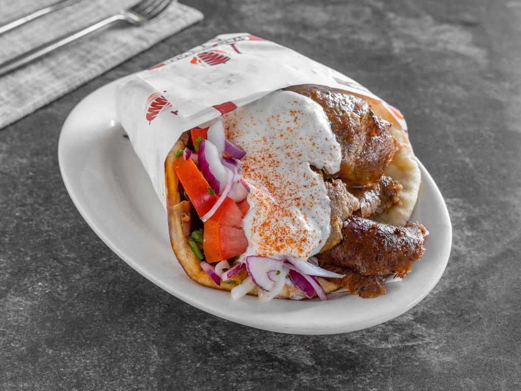 Gyro Sandwich · Sliced beef and lamb on a pita bread with onions,tomatoes , and  white sauce 