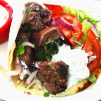 Shish Kabob Sandwich (beef) · Beef kabob on a pita with lettuce, tomatoes, onions and white sauce