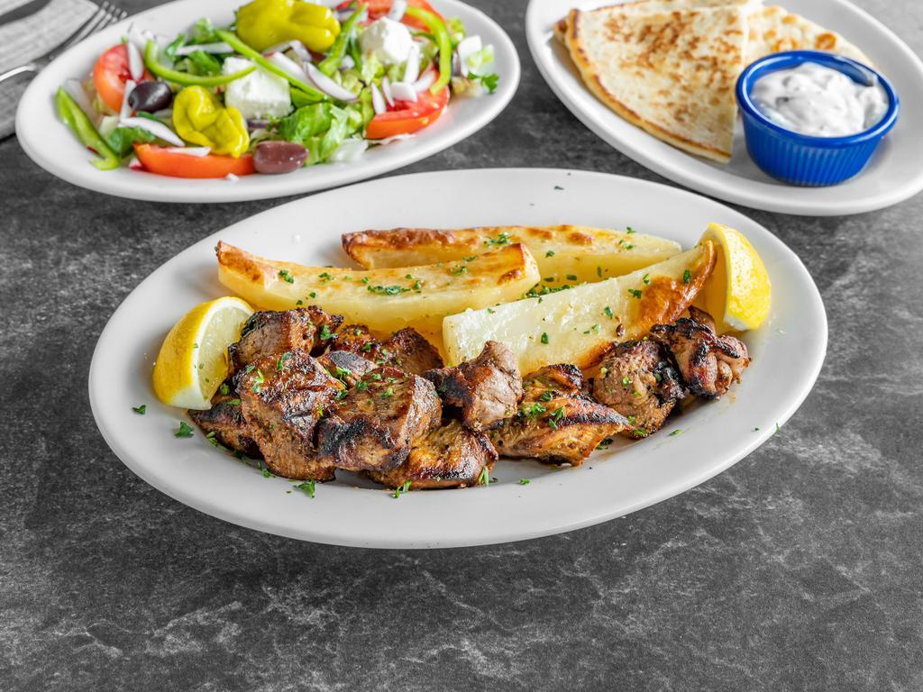 Souvlaki platter · Served with a side salad, one pita bread, one small tzatziki, also your choice of either lemon potatoes, rice, fries, or peas w carrots. 