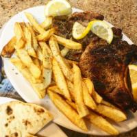 Pork Chops · Served with salad, pita, sauce and choice of lemon potatoes , rice,  fries, or peas.