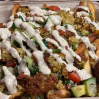 Loaded Falafel Fries · A large fry topped with crushed falafel, tabbouleh, and mediterranean salad. Finished with a...
