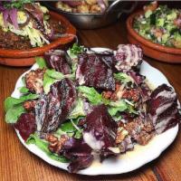 Charred Beets · Tahini, silan, mixed greens and walnuts. Vegan.