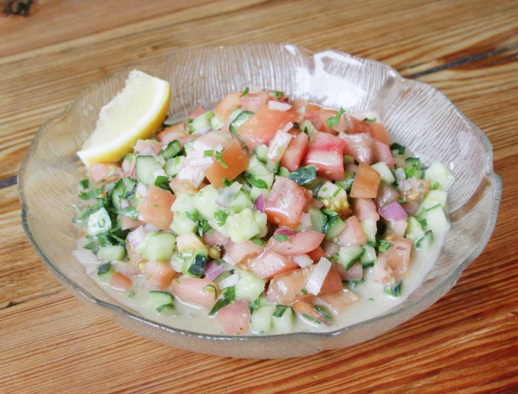 Mediterranean Chopped Salad · Tomato, cucumber, onion, parsley and mint mixed with lemon and extra virgin olive oil. Vegan.
