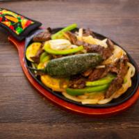 Fajitas For 1 · Served with over sauteed onions and bell peppers and guacamole lettuce pico charro or re-fri...