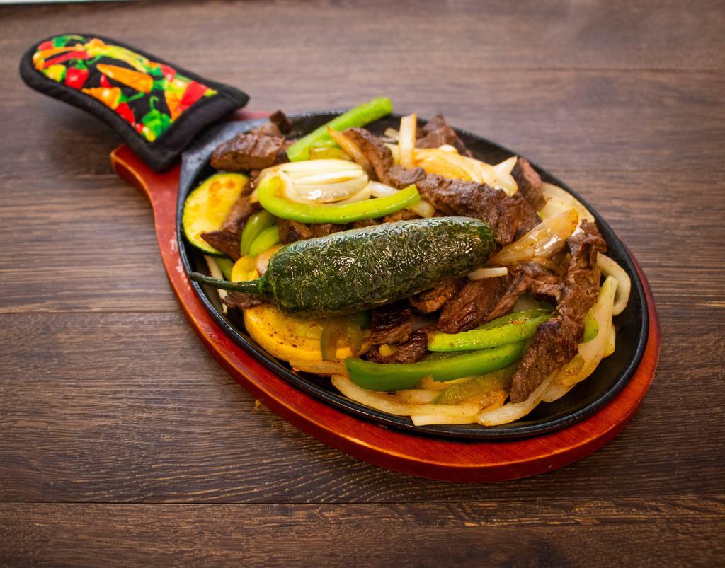 Fajitas For 1 · Served with over sauteed onions and bell peppers and guacamole lettuce pico charro or re-fried beans and rice. Flour or corn tortilla. 