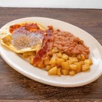 Huevos rancheros · Two eggs cooked over easy covered in our homemade ranchero saucewith avocado slice on top. I...