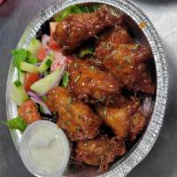 Sweet chili wings served with salad or fries · Chicken season and marinated with herbs and spices, deep fried in olive oil and top of with ...