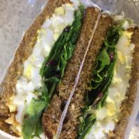 Egg Salad Toast · Egg salad with baby spring mix on top of toasted bread. Vegetarian.