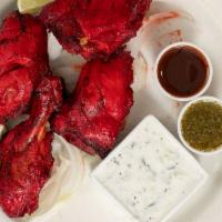 Tandoori Chicken · Chicken leg quarters marinated in fresh spices, herbs and yogurt, barbecued over flaming cha...