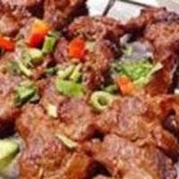Lamb Boti Kabab · Boneless lamb prepared in fresh spices, herbs and yogurt and broiled in tandoor. Served with...