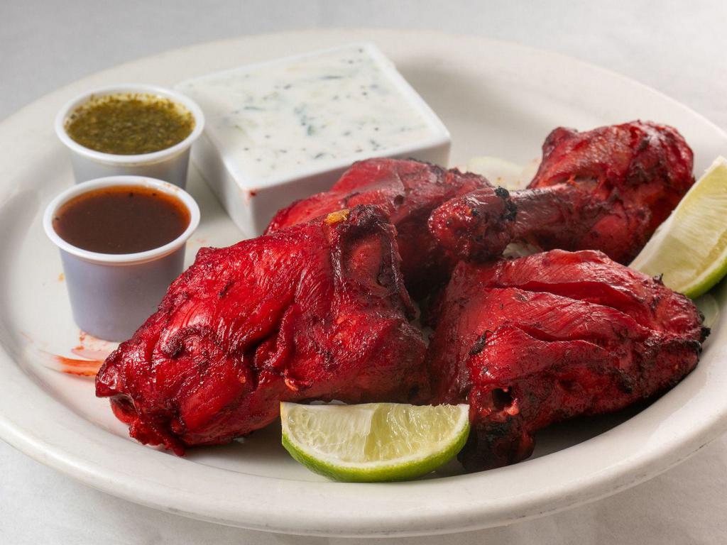 Chicken Tikka · Tender boneless chicken breast marinated in fresh spices, herbs, and yogurt, barbecued on a skewer in flaming charcoal in tandoor. Served with Basmati Rice