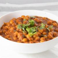 Channa - Chick Peas (V) · Chick Peas cooked in onion, ginger, garlic paste with Indian spices & herbs. Served with Bas...
