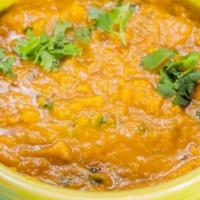 Dal Tadka (V) · Lentils cooked with Indian spices, ginger, & garlic paste. Served with Basmati rice