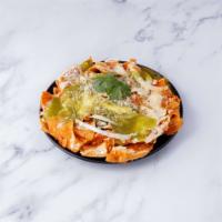 Chilaquiles Regulares · Corn tortilla chips cooked with green or red hot sauce, sprinkled cheese, onions and sour cr...